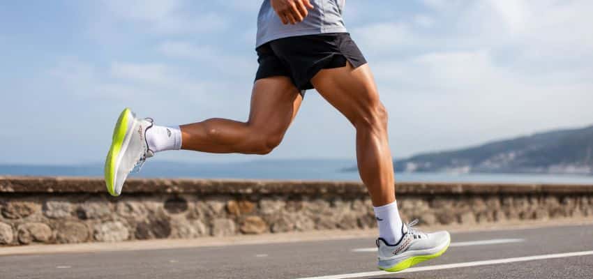 Runner wearing running shoes for heavier beginners with knee pain on a paved road.