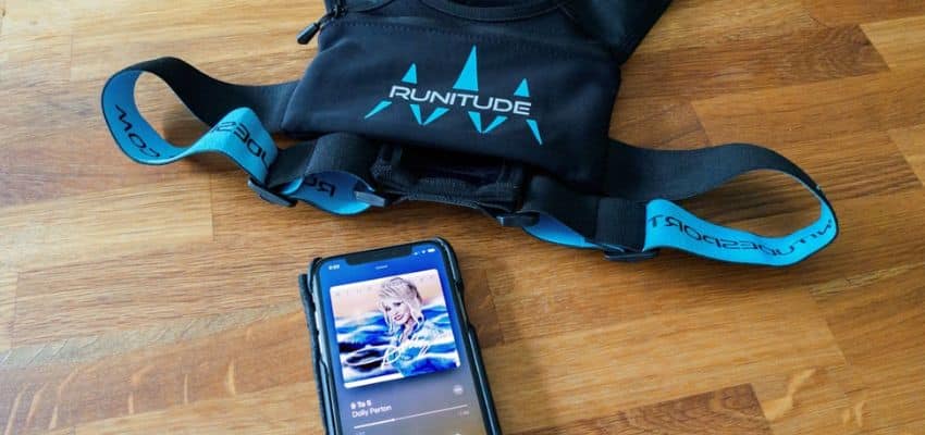 Running waist pack and smartphone on a wooden table, showing a practical way to carry a phone and essentials while running.