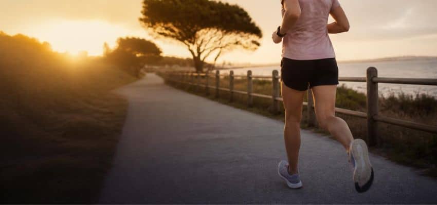 Running cadence for beginners during an easy run on a waterfront path